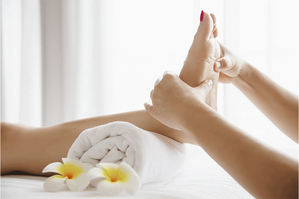 Woman foot receiving reflexology massage Holistic Centre